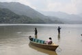 Three Boys Fishing in a Mountainous Lake in Nepal