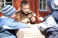 Three boys are going to have their lunch outside