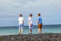 Three boys have fun at the black volcanic beach Royalty Free Stock Photo