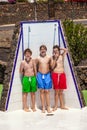 Three boys have fun unter the pool shower Royalty Free Stock Photo
