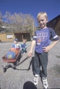 Three boys with their red wagon in CO