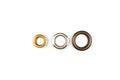 Three brass multicoloured metal eyelets or rivets - curtains rings for fastening fabric to the cornice, isolated on Royalty Free Stock Photo