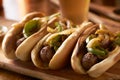 Three bratwurst sausages with grilled onions and bell peppers Royalty Free Stock Photo
