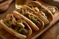 Three bratwurst sausages with grilled onions and bell peppers Royalty Free Stock Photo