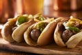 Three bratwurst sausages with grilled onions and bell peppers Royalty Free Stock Photo