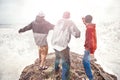 Three brave men standing on a cliff