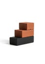 Three bricks are stacked in a step-like formation against a white Royalty Free Stock Photo