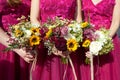 Three bridesmaids in lilac lace dresses with bouquets of fresh flowers, selective focus Royalty Free Stock Photo