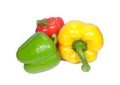 Three bright color ripe bell peppers, one green, one yellow and one red isolated on white background Royalty Free Stock Photo