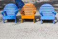 Three bright colored beach chairs on the sand with bottom copy s Royalty Free Stock Photo