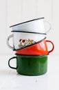 Three bright colorful enameled mugs Royalty Free Stock Photo