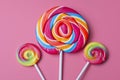 Three bright and colourful candy lollipops on a pink background Royalty Free Stock Photo