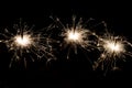 Three bright festive Christmas sparklers on black Royalty Free Stock Photo