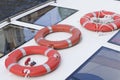 Three bright orange lifebuoys