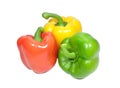 Three bright yellow, green, red color ripe bell peppers isolated on white background Royalty Free Stock Photo