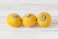 Three bright yellow turnips on white wooden background Royalty Free Stock Photo