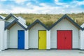 Three brightly coloured beach huts at Swanage in Dorset