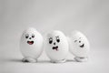 Three broken eggs with funny emoticons Royalty Free Stock Photo