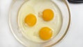 Three broken eggs for making French omelet in a glass bowl Royalty Free Stock Photo