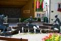 Three bronze statues of musicians playing some instruments with a fountain in the middle in Vianden, Luxembourg. Vianden