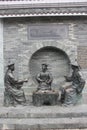 Three bronze statues of officials in the Qing Dynasty