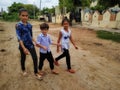 Three brother and sisters walking on the path