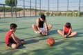 Three brothers doing leg stretching exercises