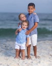 Three brothers embracing one another on a beach Royalty Free Stock Photo
