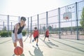 Three brothers playing basketball, one of them has a leg prosthesis Royalty Free Stock Photo