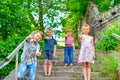 Three brothers and sister stand on the steps in the park and show the class
