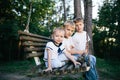 Three brothers sitting on swing Royalty Free Stock Photo