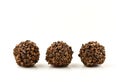 Three brown balls of chocolate with a grainy texture Royalty Free Stock Photo