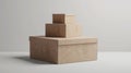 Three brown cardboard boxes stacked in a pyramid shape on a plain background, with the largest box at the bottom and the Royalty Free Stock Photo