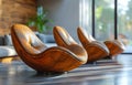 Three brown chairs are sitting in a room with a large window Royalty Free Stock Photo