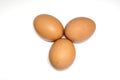 Three brown chicken eggs on white Royalty Free Stock Photo