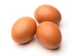 Three brown eggs isolated against white background