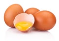 Three brown raw eggs and one is broken isolated white on white background Royalty Free Stock Photo