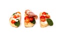 Three bruschetta on a ciabatta on a white plate. Italian appetizer Royalty Free Stock Photo