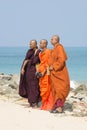 Three Buddhist monks on the background of the ocean
