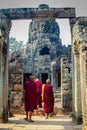 Buddhist monks enter the Bayon Temple at Angkor Wat, Siem Reap, Cambodia