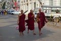 Three Buddhist monks walking down a street in Yangon, Myanmar