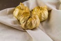 Three smoked garlic bulbs on hessian cloth surface