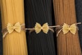 Three bunches of different types of Italian spaghetti. Black, brown and yellow spaghetti. Close up Royalty Free Stock Photo