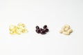 Three bunches of multivitamins, fish oil and astaxanthin. White background. Close-up