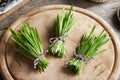 Three bundles of fresh young green barley grass blades on a table Royalty Free Stock Photo