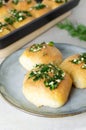 Three buns with garlic and dill sauce with oil in a gray plate. Preparation of pampushky (Pampushky)