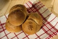 Three buns of wheat flour on a white towel with red stripes. Belgian bread. Closeup Royalty Free Stock Photo