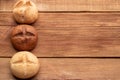 Three buns on wooden table Royalty Free Stock Photo
