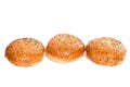 Three burger buns with sesame seeds on white background Royalty Free Stock Photo