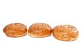 Three burger buns with sesame seeds on white background Royalty Free Stock Photo